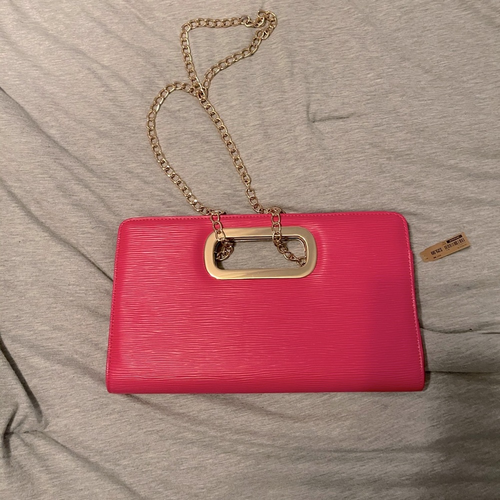 Hot pink Call It Spring clutch with hanging chain.